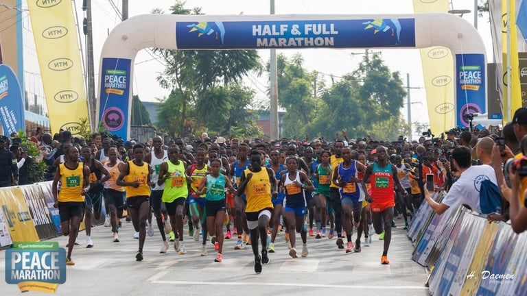 Large group of runners at the start of a half and full marathon race event under a blue banner