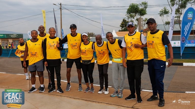 Group of people wearing yellow Peace Marathon shirts standing together outdoors at an event venue