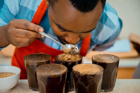 Child spooning soil into transparent containers during a science experiment or educational activity