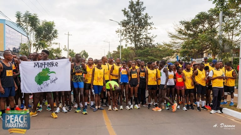 Large group of people wearing yellow and blue shirts gathered on a street for a peace marathon event, holding signs including one with a tree design